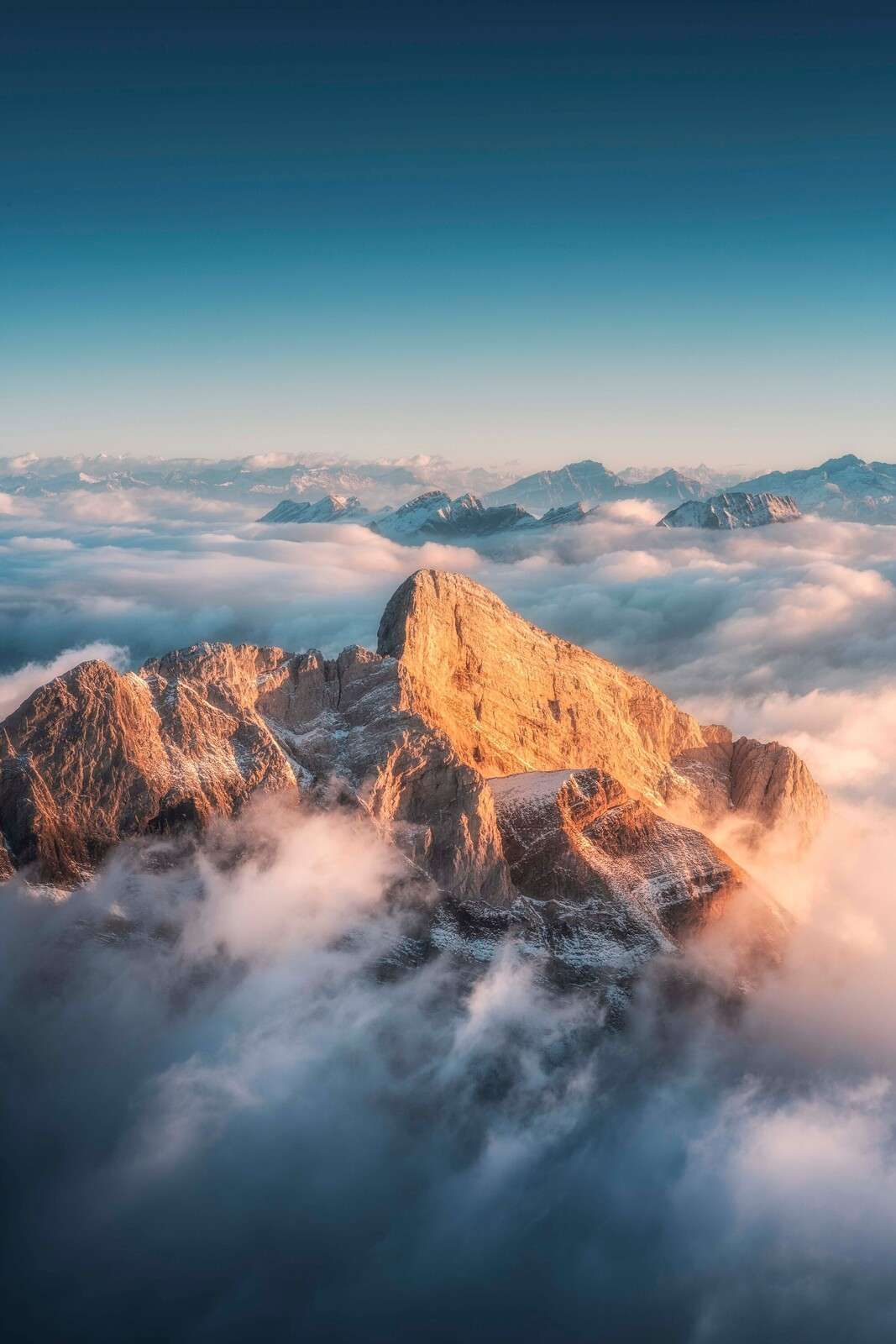 Golden mountaintop in morning mist