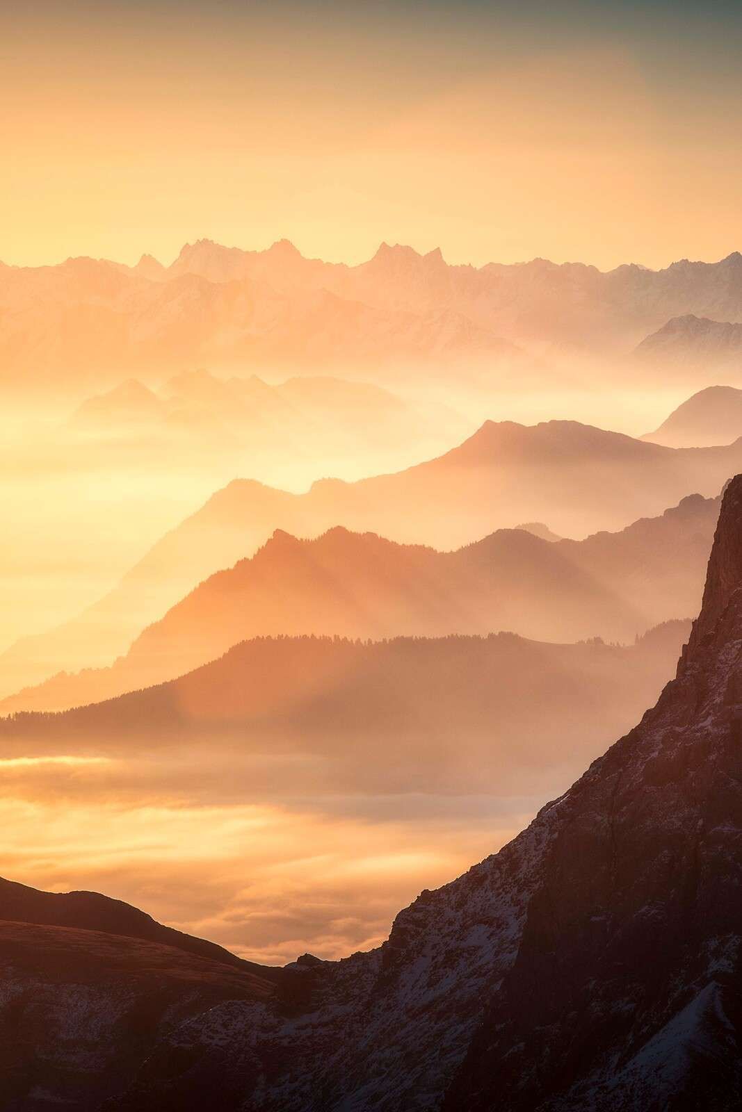 Layered mountain silhouettes at sunrise