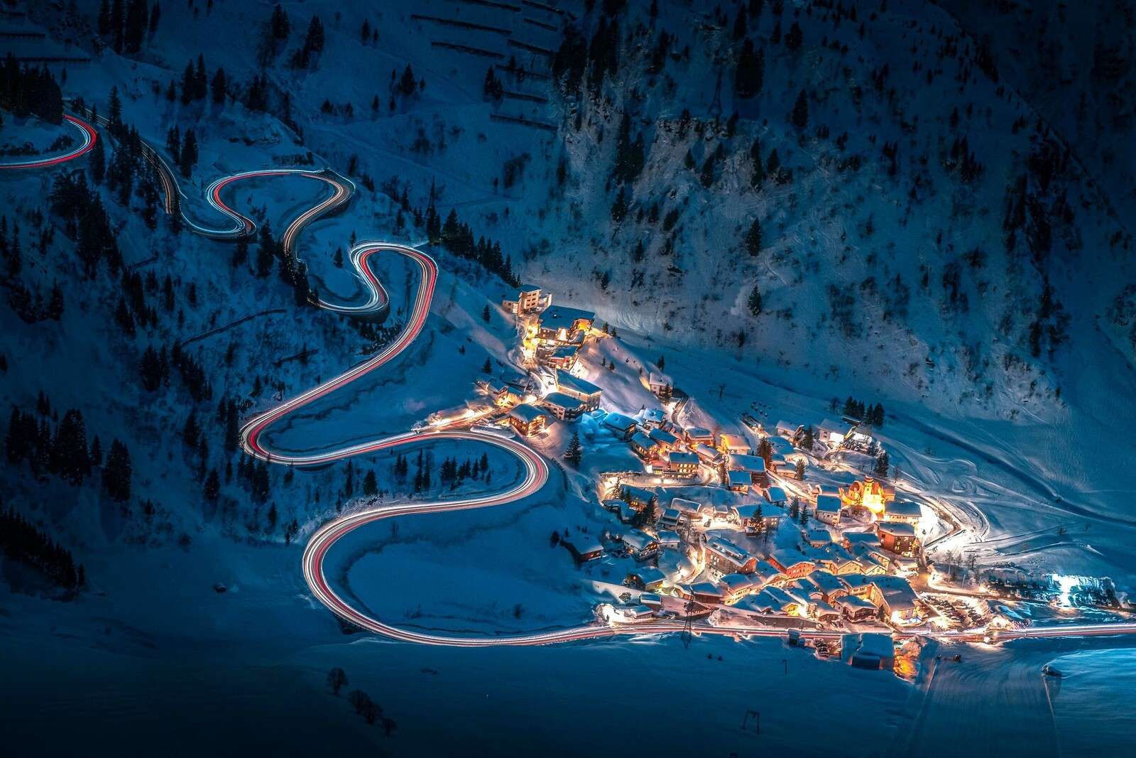 Enlightened mountain village with winding mountain road