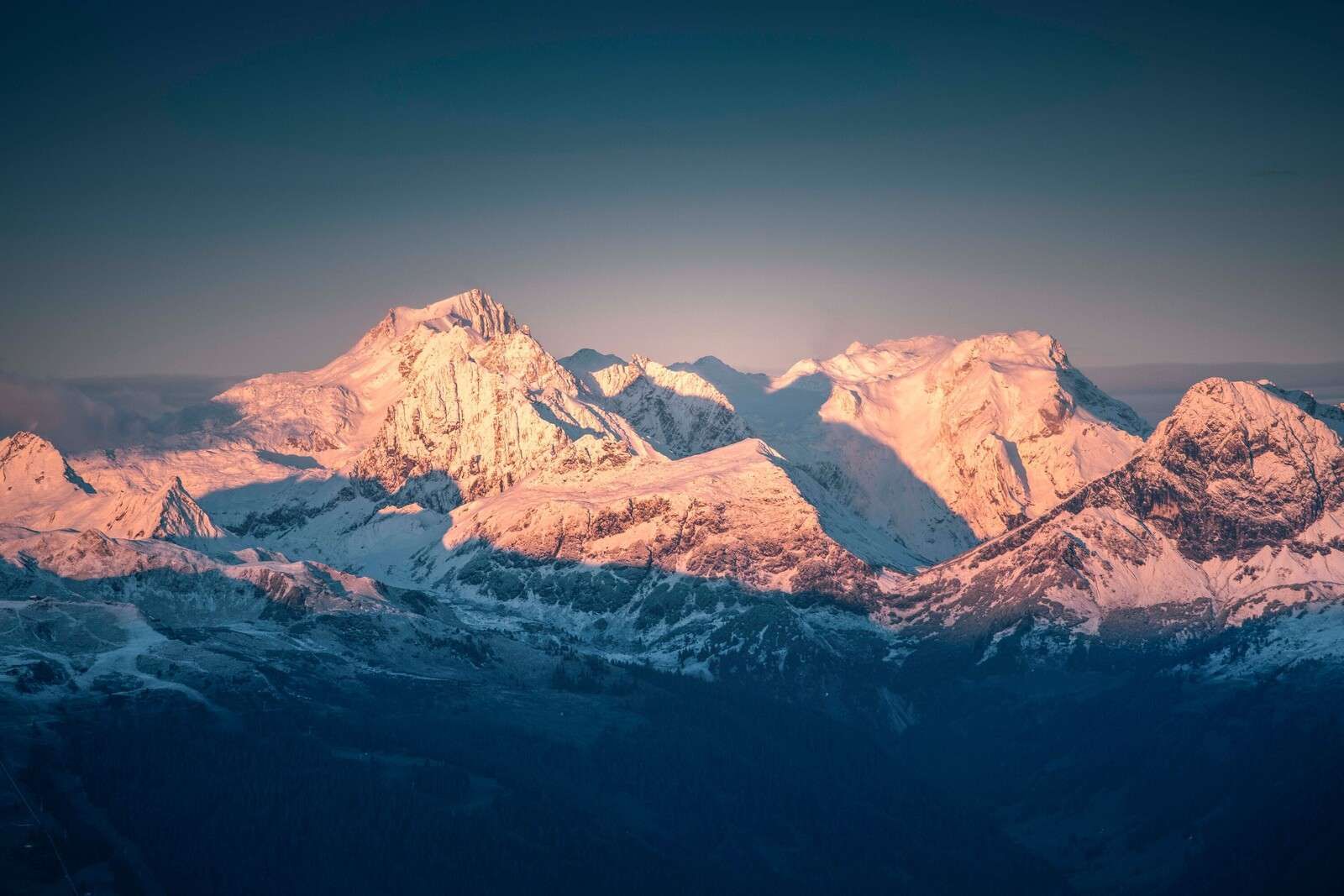 Morning light on snow-capped mountain peaks