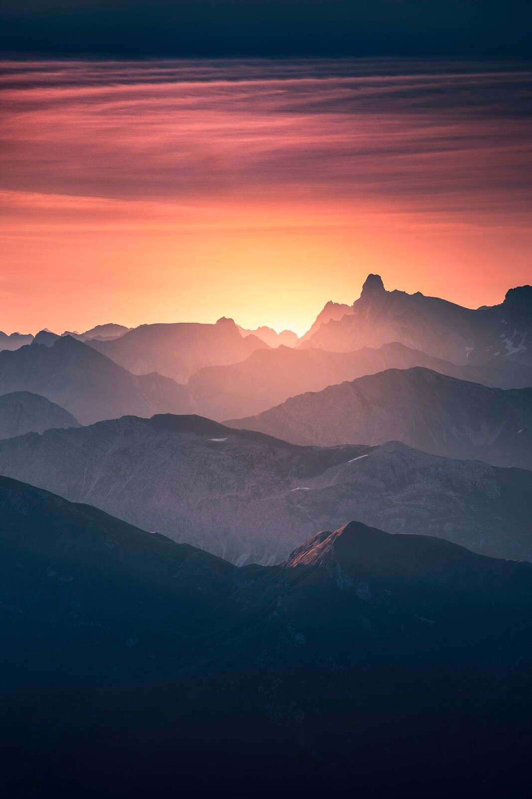 Sunrise over purple mountain slopes