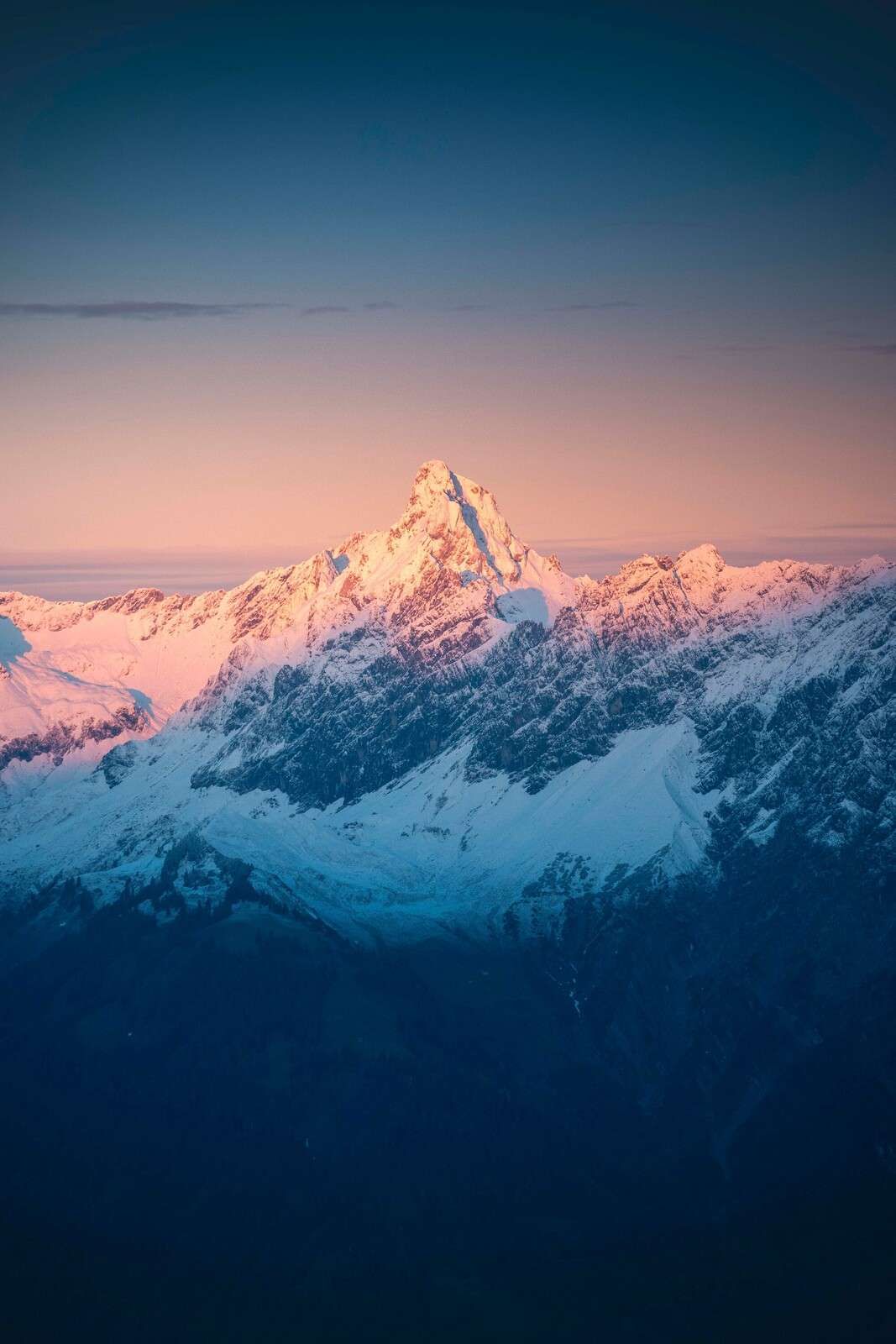 Evening light on snow-capped mountain peak