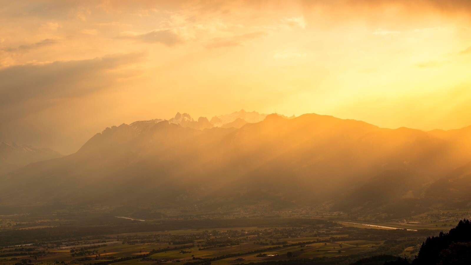Golden sunlight over mountain valley