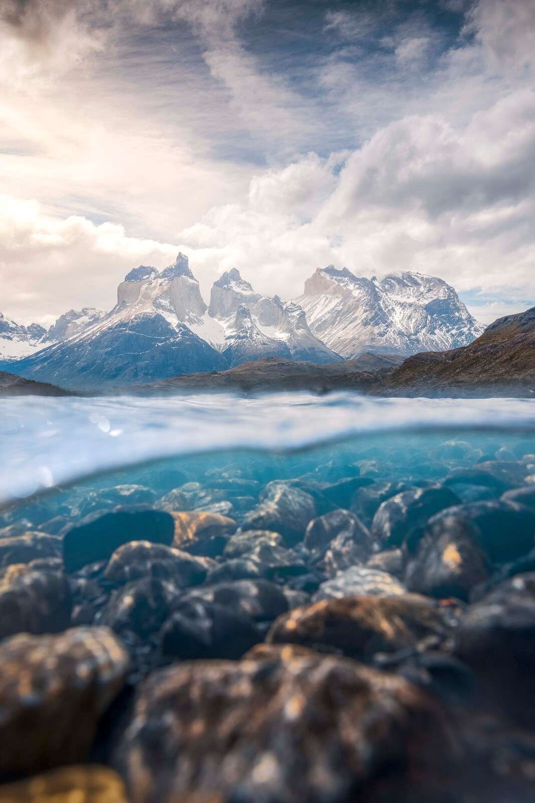 Clear glacier lake with mountain peaks