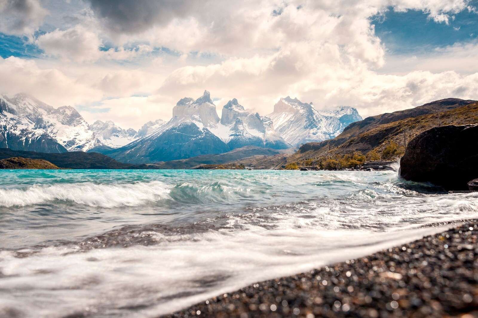 Turquoise mountain lake with rolling coast
