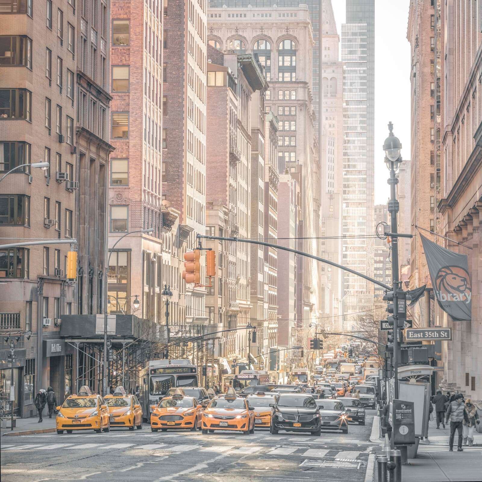 Busy city street with yellow taxis