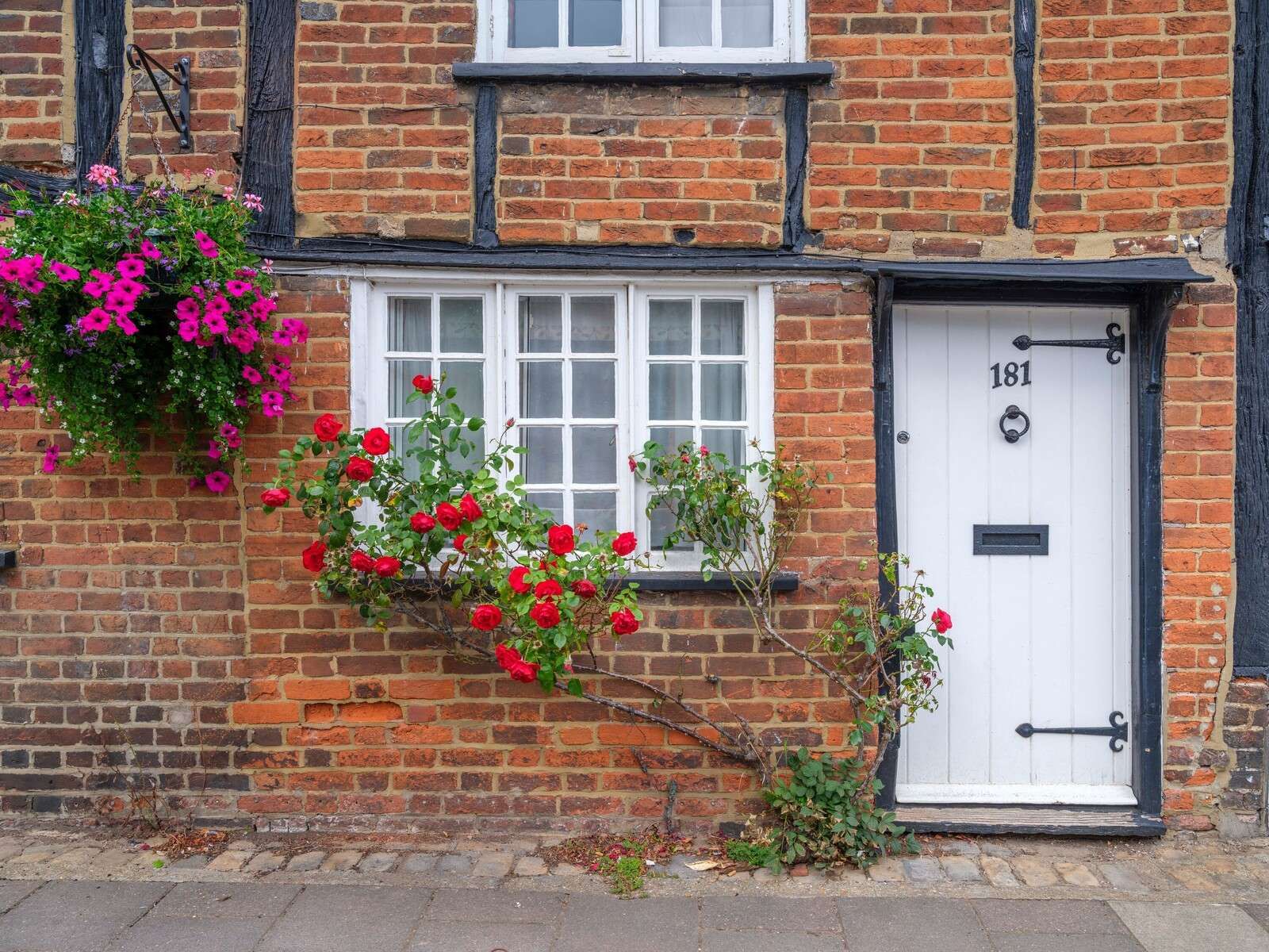 Brick cottage with red roses