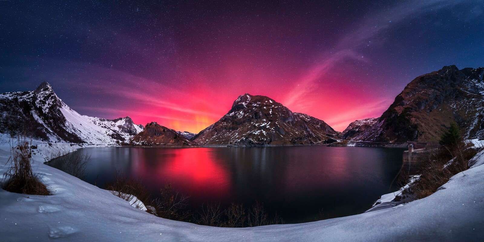 Northern lights above a mountain lake
