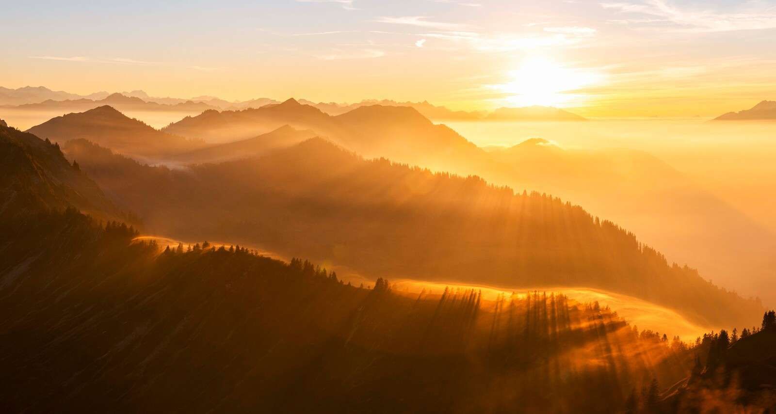Sun rays over mountainous landscape