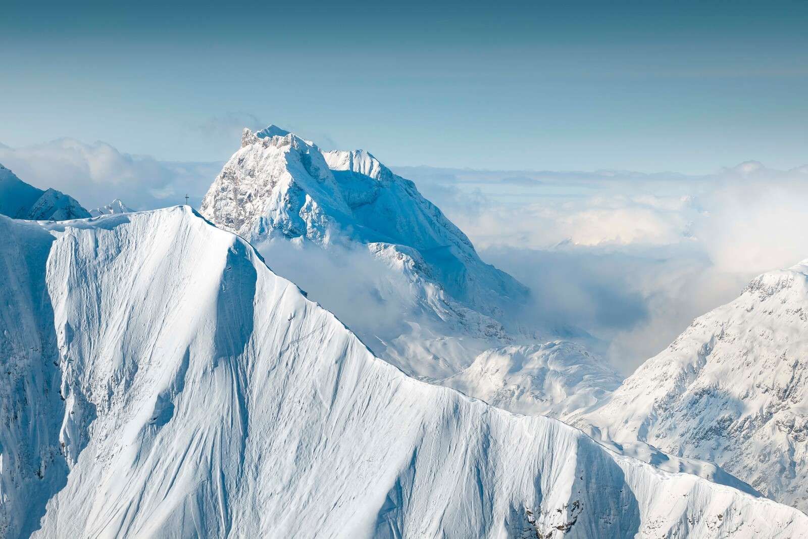 Snow-covered mountains above the cloud cover