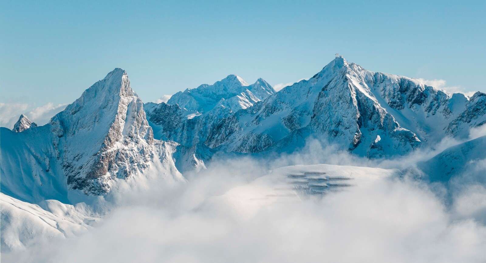 Snow-covered mountain peaks in mist