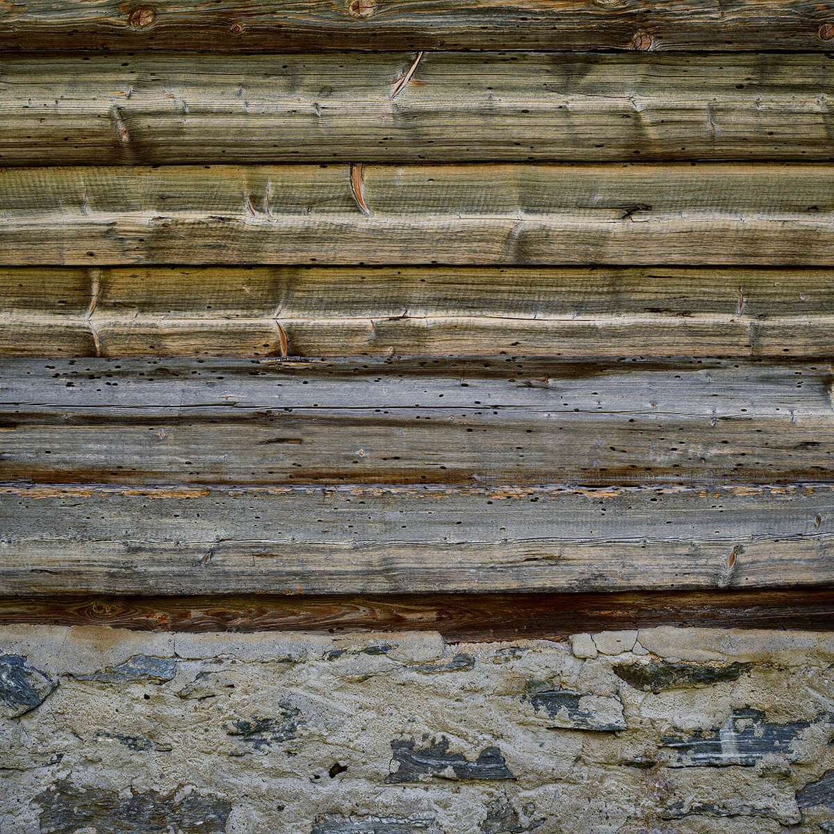 Weathered wood on stone wall