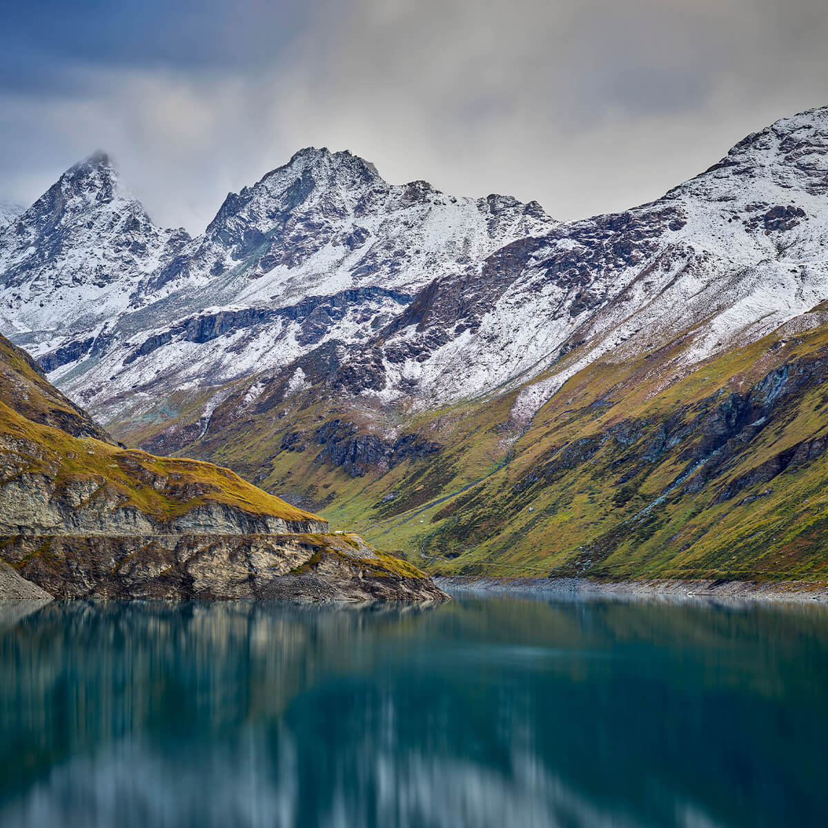 Mountain peaks with snow near mountain lake