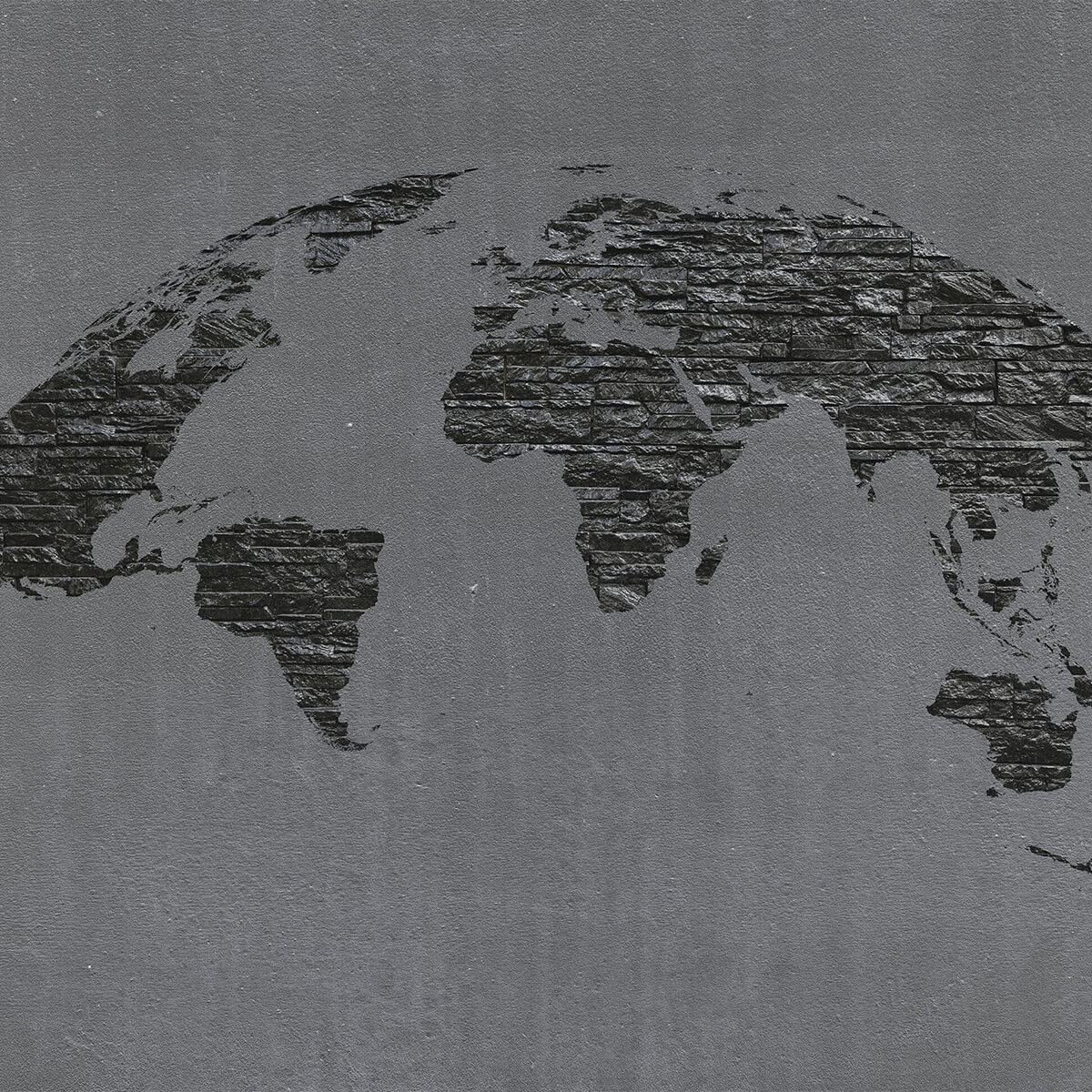 Pierres de la carte du monde sur du béton gris